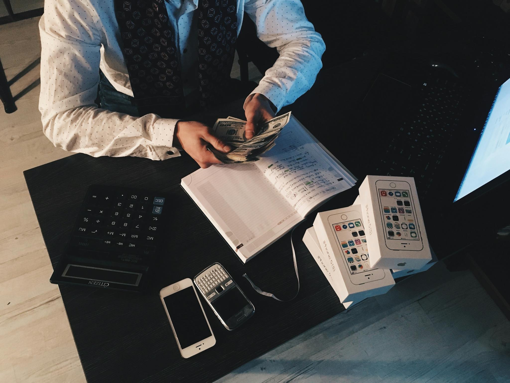 Businessman Organizing Finances With Tech Devices And