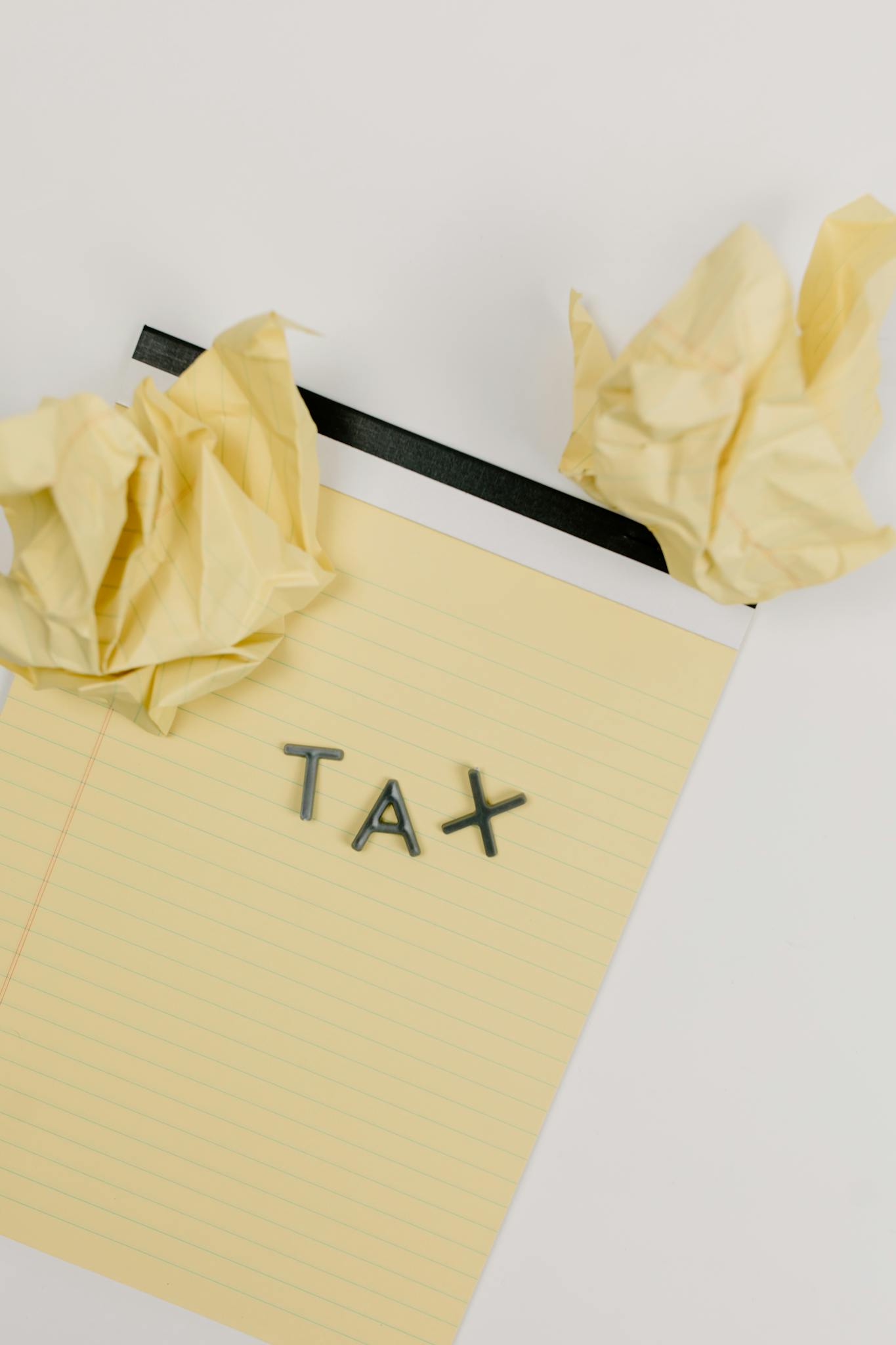 Yellow Notepad Featuring The Word Tax With